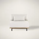 Contemporary outdoor armless lounge chair with white cushions, natural wood base, and black metal legs.