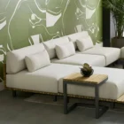 Contemporary outdoor armless lounge chair with white cushions, natural wood base, and black metal legs.