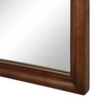 A sleek oval-shaped Renwell Kindra Mirror with a thin, minimal metal frame in a warm brass finish, mounted on a light-toned wall.