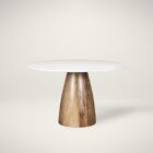 Round white marble dining table with a solid wood tapered cone-shaped base in a natural finish.