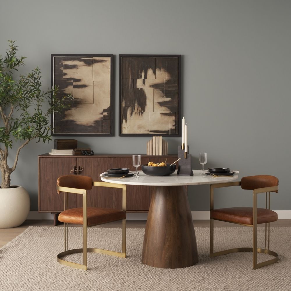 Round white marble dining table with a solid wood tapered cone-shaped base in a natural finish.