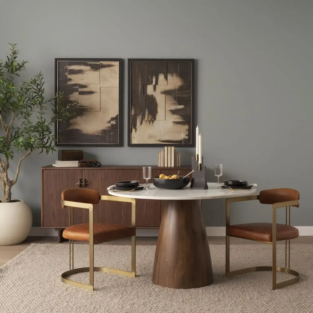 Round white marble dining table with a solid wood tapered cone-shaped base in a natural finish.