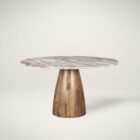 Round dining table with a polished pink marble top and smooth wood pedestal base.