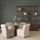 Round dining table with a polished pink marble top and smooth wood pedestal base.