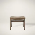 Low wood accent stool with woven cane seat and sculpted legs in a weathered oak finish.