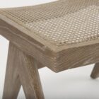 Low wood accent stool with woven cane seat and sculpted legs in a weathered oak finish.
