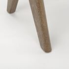 Low wood accent stool with woven cane seat and sculpted legs in a weathered oak finish.