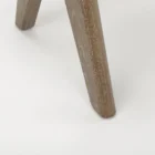 Low wood accent stool with woven cane seat and sculpted legs in a weathered oak finish.