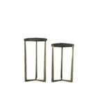Pair of round nesting accent tables with charcoal wood tops and antique brass metal frames.