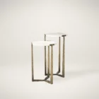 Set of two round white marble nesting tables with antique brass metal bases.