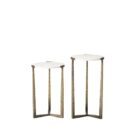 Set of two round white marble nesting tables with antique brass metal bases.
