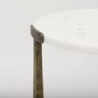 Set of two round white marble nesting tables with antique brass metal bases.