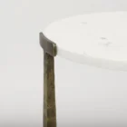 Set of two round white marble nesting tables with antique brass metal bases.