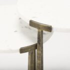 Set of two round white marble nesting tables with antique brass metal bases.