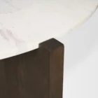 Round marble-top coffee table with cross-shaped dark wood base.