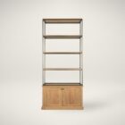Tall bookcase with brass-toned metal frame, natural wood shelves, and a closed wood cabinet at the base.