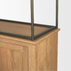 Tall bookcase with brass-toned metal frame, natural wood shelves, and a closed wood cabinet at the base.