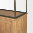 Tall bookcase with brass-toned metal frame, natural wood shelves, and a closed wood cabinet at the base.