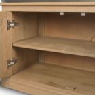 Tall bookcase with brass-toned metal frame, natural wood shelves, and a closed wood cabinet at the base.