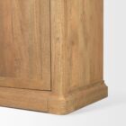 Tall bookcase with brass-toned metal frame, natural wood shelves, and a closed wood cabinet at the base.