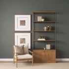 Tall bookcase with brass-toned metal frame, natural wood shelves, and a closed wood cabinet at the base.