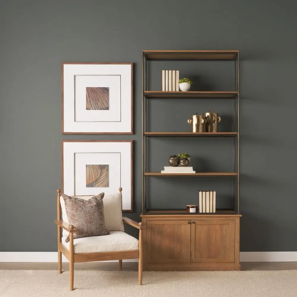 Tall bookcase with brass-toned metal frame, natural wood shelves, and a closed wood cabinet at the base.