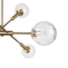 Modern chandelier with six hammered glass globe bulbs and a brushed brass angular frame.