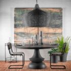 Black metal wire-frame chandelier with a curved silhouette and exposed four-bulb candelabra fixture inside.