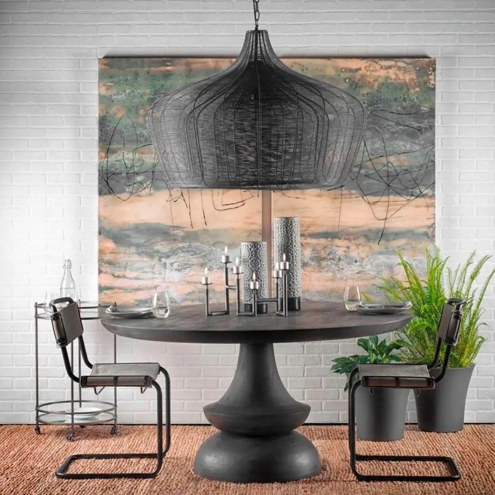 Black metal wire-frame chandelier with a curved silhouette and exposed four-bulb candelabra fixture inside.
