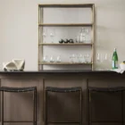 Minimalist counter-height stool with dark woven leather seat and slender black metal frame.