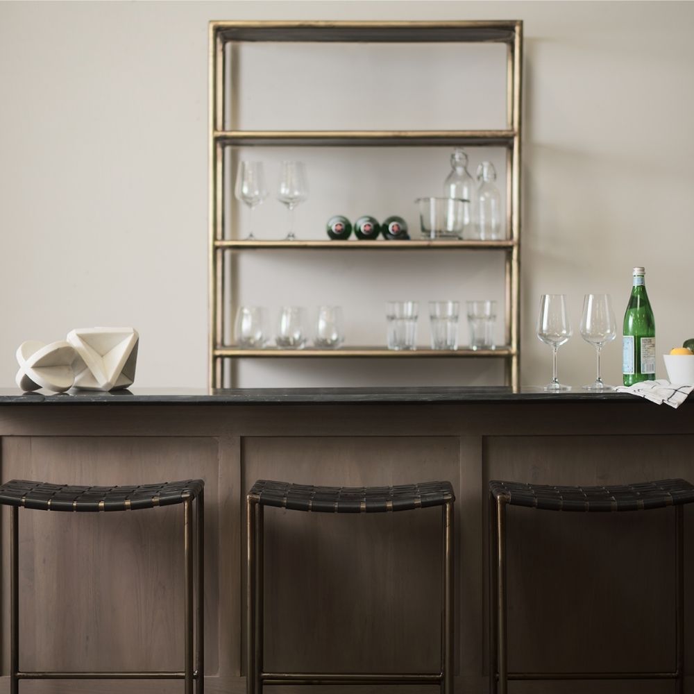 Minimalist counter-height stool with dark woven leather seat and slender black metal frame.