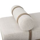 Mercana Colburne bench with beige cushion, natural wood base, and black metal legs, featuring a strapped bolster pillow.