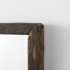Rustic vertical wall mirror with thick reclaimed wood frame and natural imperfections.