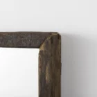 Rustic vertical wall mirror with thick reclaimed wood frame and natural imperfections.