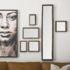 Rustic vertical wall mirror with thick reclaimed wood frame and natural imperfections.