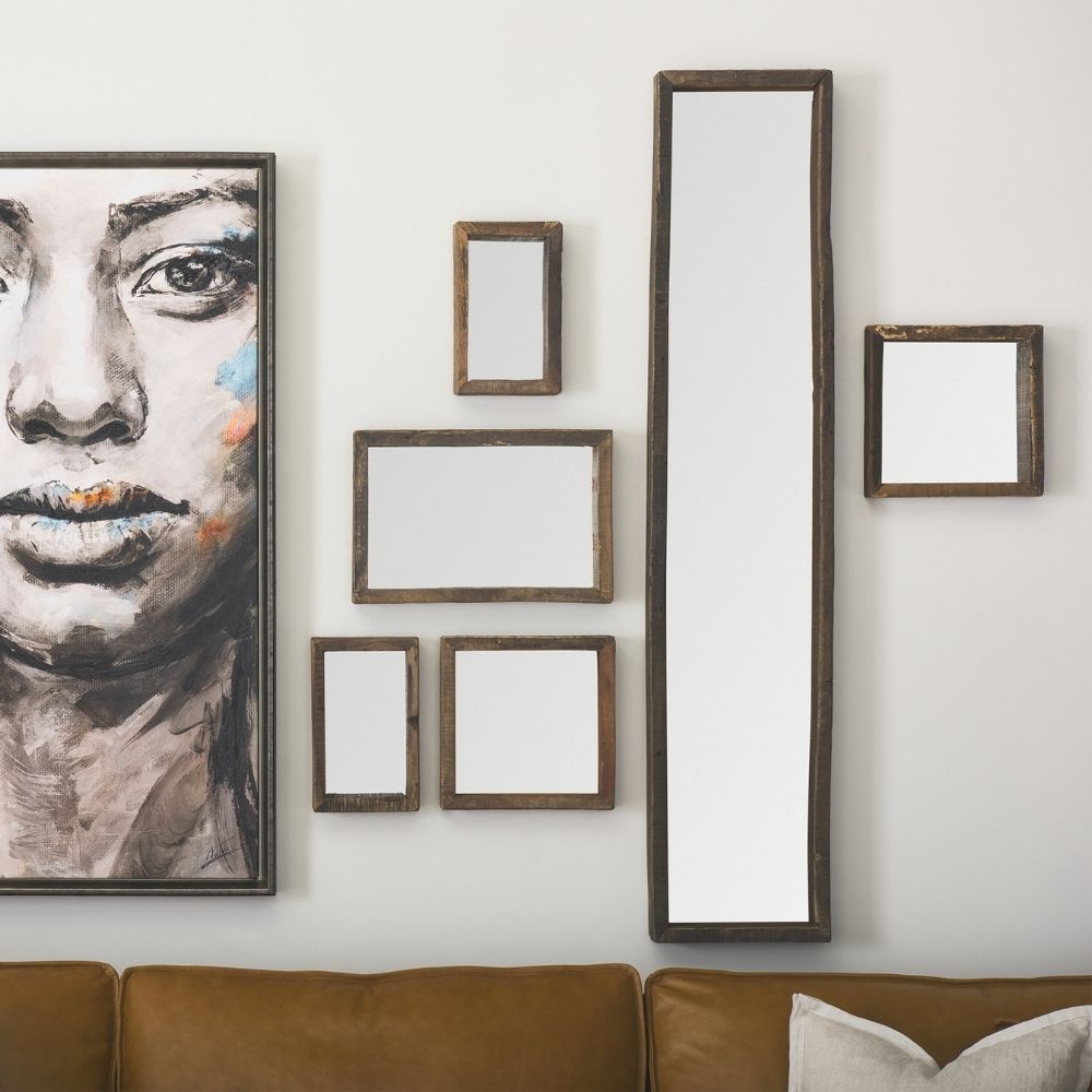 Rustic vertical wall mirror with thick reclaimed wood frame and natural imperfections.