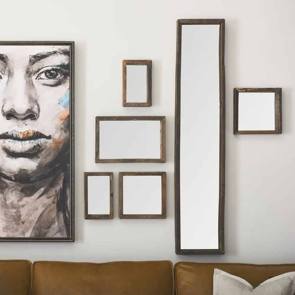 Rustic vertical wall mirror with thick reclaimed wood frame and natural imperfections.