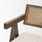 Mid-century style wooden bar stool with cane backrest, beige fabric seat, and angled frame.