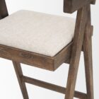 Mid-century style wooden bar stool with cane backrest, beige fabric seat, and angled frame.