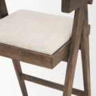 Mid-century style wooden bar stool with cane backrest, beige fabric seat, and angled frame.