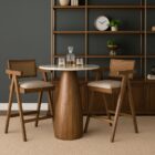 Mid-century style wooden bar stool with cane backrest, beige fabric seat, and angled frame.