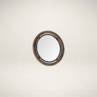 Round wall mirror with mixed wood and metal frame in industrial black and natural finish.