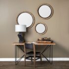 Round wall mirror with mixed wood and metal frame in industrial black and natural finish.