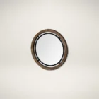 Round wall mirror with mixed wood and metal frame in industrial black and natural finish.