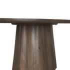 Dark wood oval dining table with sculpted fluted pedestal base.