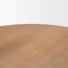 Round natural wood dining table with sculptural pedestal base.