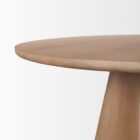 Round natural wood dining table with sculptural pedestal base.