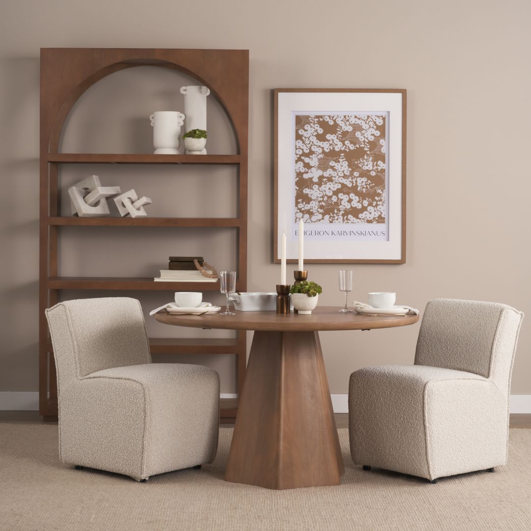Round natural wood dining table with sculptural pedestal base.