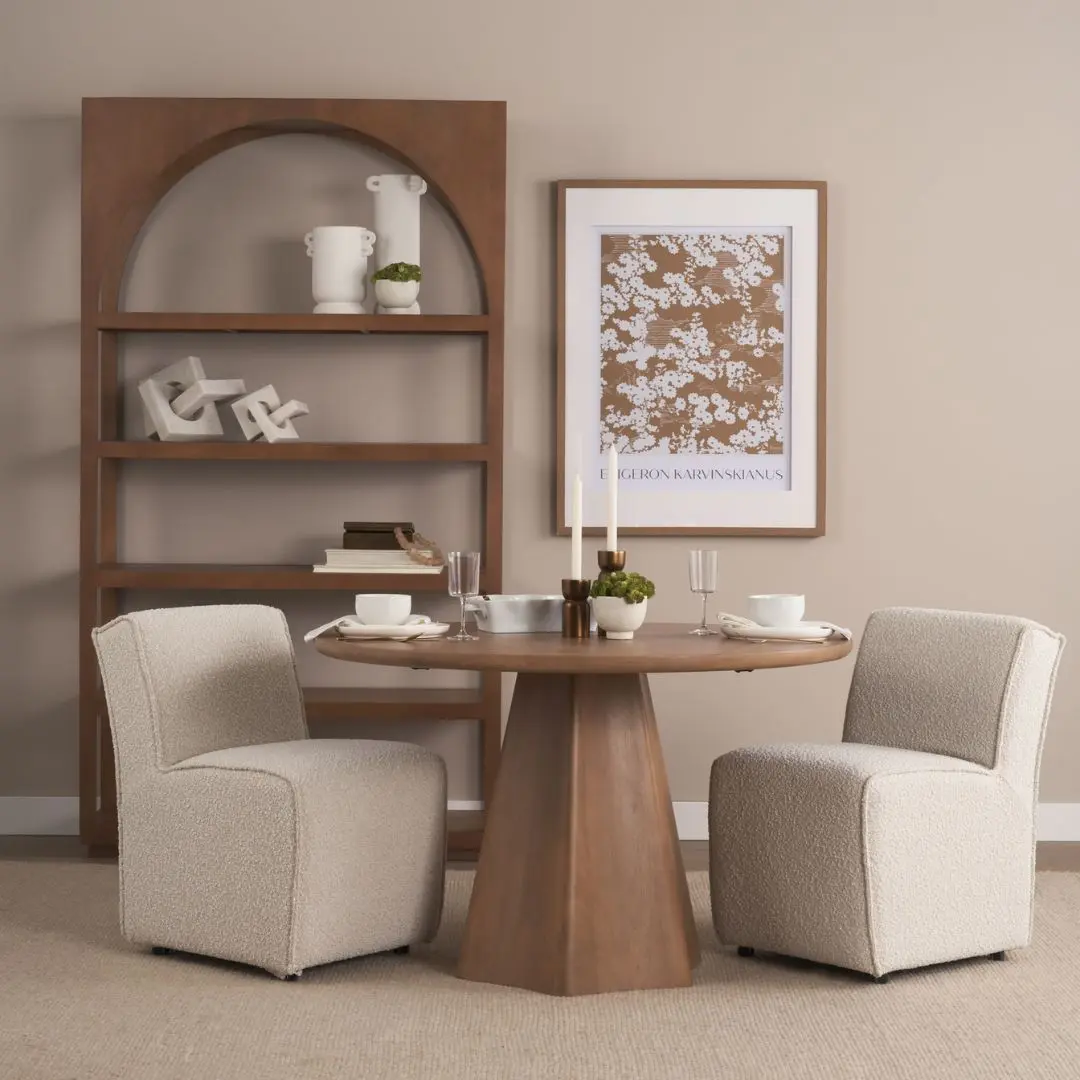 Round natural wood dining table with sculptural pedestal base.