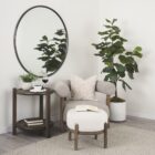 Round wall mirror with slim metal frame.